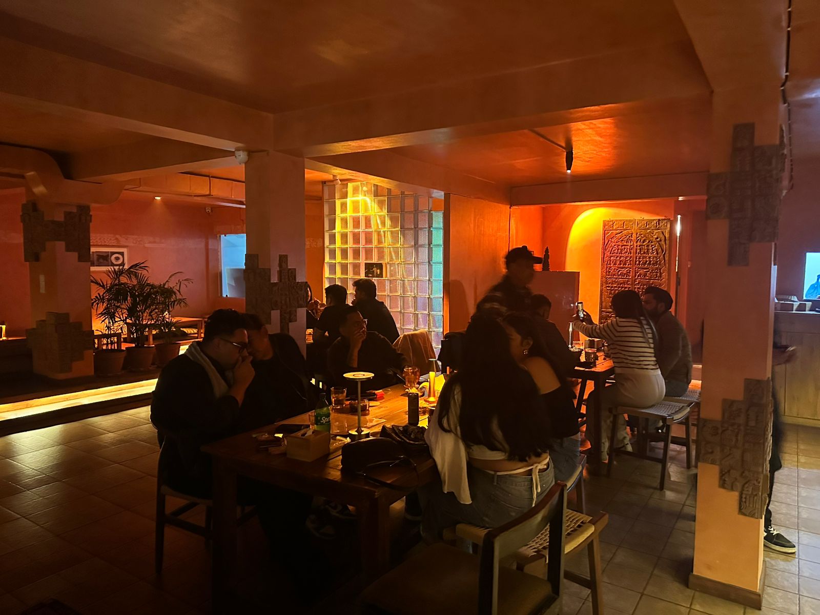 KohBar interior with warm amber lighting and guests