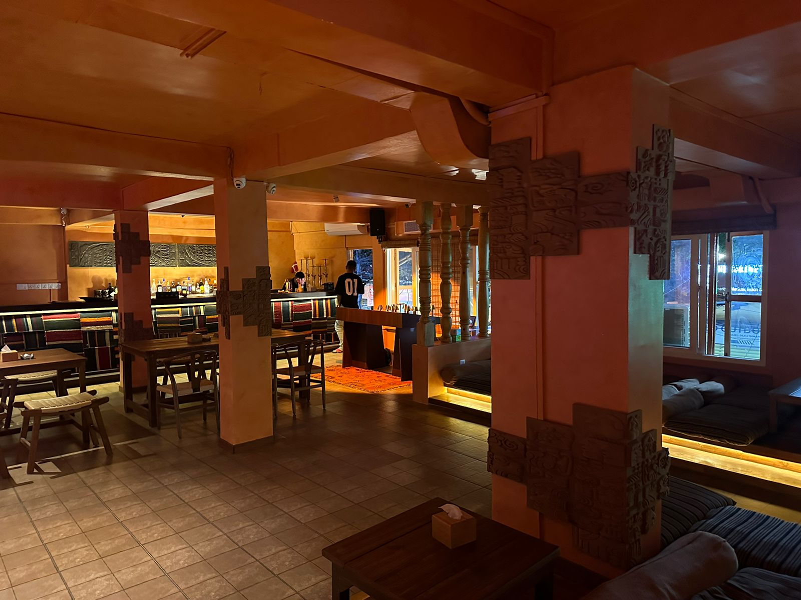 KohBar interior with carved wooden columns and Mithila art decorations